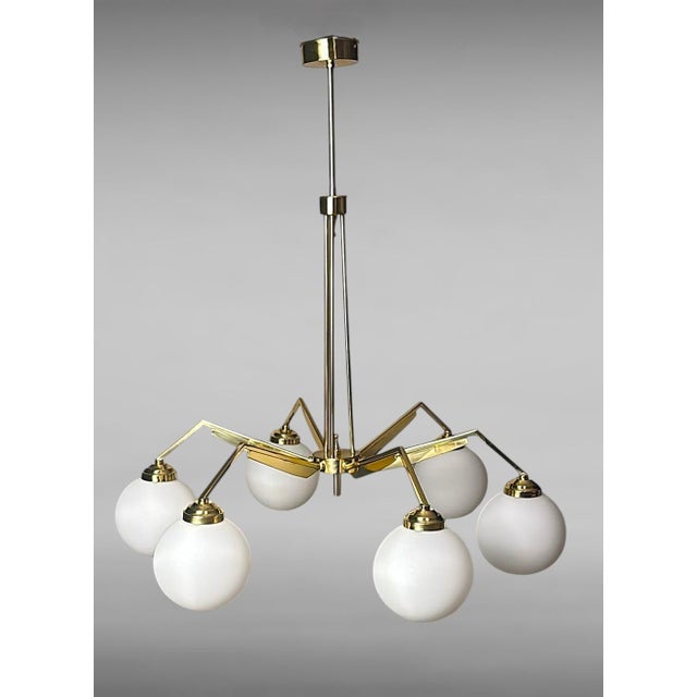 A stunning and highly decorative Italian vintage chandelier, featuring a substantial structure crafted from solid brushed...