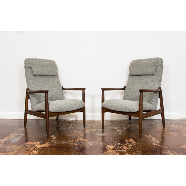 A pair of GFM-64 armchairs in a high-back version, designed by Edmund Homa, manufactured at the Gościcińska Furniture...