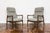 A pair of GFM-64 armchairs in a high-back version, designed by Edmund Homa, manufactured at the Gościcińska Furniture...