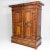 Two-door rustic cabinet with turned pilasters and profiled cornice with cranked corners. Two wide drawers are in the base....