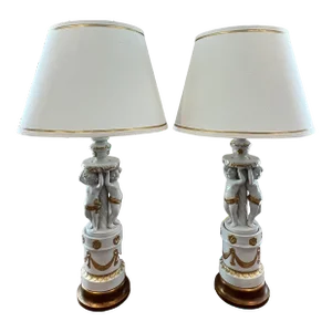 1960s Hollywood Regency Cherub-Themed Table Lamps in White Porcelain Hand-Painted With Gold + Linen Shades - a Pair