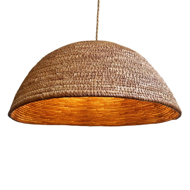 Crafted from a genuine vintage basket woven by the Dogon people of Mali, this pendant light carries both sculptural...