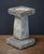 A fine English garden bird bath of composition stone, featuring a square top with round recessed bath area in the center...