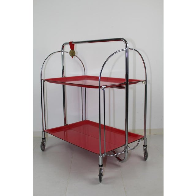 Bar trolley by Bremshey / Solingen, so-called Dinette, 2-sided folding, orange-red plastic plates, chrome frame. I have...