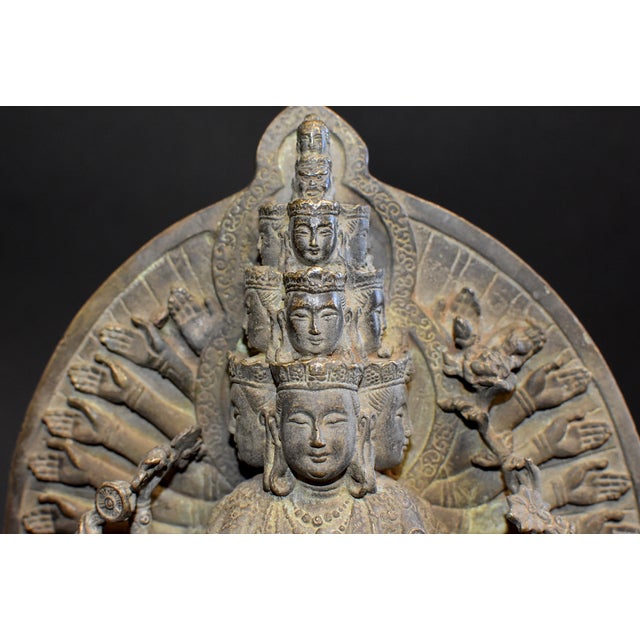 A most exquisite bronze Multiple Headed and Armed Avalokitesvara Guan Yin statue. Standing on double lotus throne with the...
