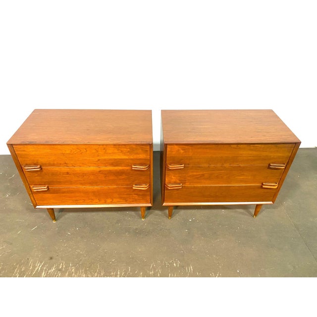 Gorgeous Pair of Custom Made walnut Dressers. Classic 50's style with sleek stylized pulls and tapered legs capped in...