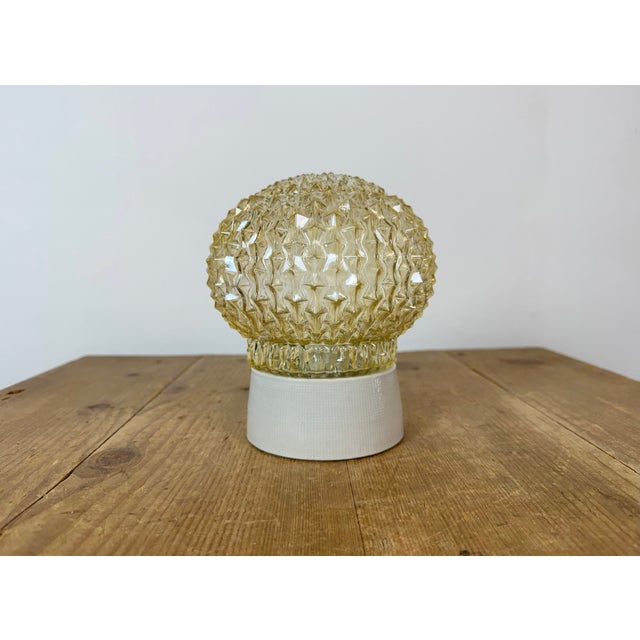 Vintage industrial ceiling or wall light made in former Czechoslovakia during the 1970s. It features a white porcelain...