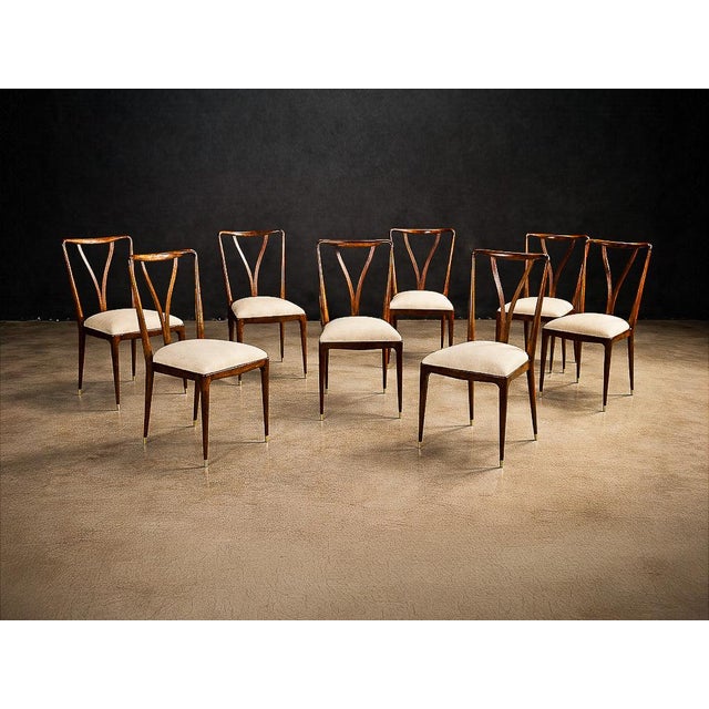 This elegant and highly sculptural set of eight dining chairs exemplifies the refined modernism of Giuseppe Scapinelli,...