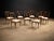 This elegant and highly sculptural set of eight dining chairs exemplifies the refined modernism of Giuseppe Scapinelli,...
