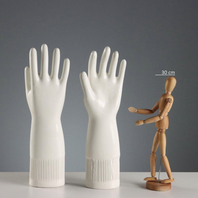 A set of five white porcelain molds for pirelli gloves. Pirelli used to make latex gloves using porcelain matrices...