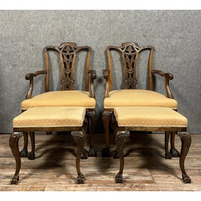 Pair of english armchairs with mahogany footrests, circa 1850, with openwork and carved backs upholstery and webbing in...