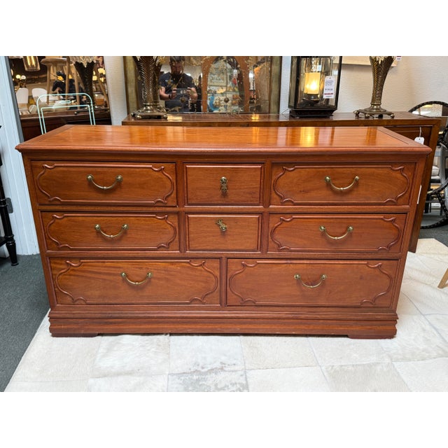 Design Plus Gallery presents a Vintage Rosewood Dresser. The case has a framed rectangular top, paneled sides, layered...