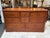 Design Plus Gallery presents a Vintage Rosewood Dresser. The case has a framed rectangular top, paneled sides, layered...
