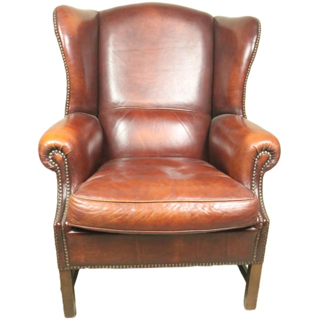 A mid 20th century English wing chair of a very large size. It is completely original in all respects including the...