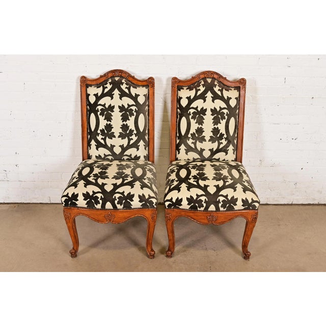 An outstanding pair of French Rococo or French Provincial Louis XV style side chairs or dining chairs By Baker Furniture...