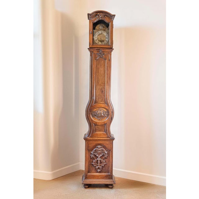 A French mid-18th century Louis XV period walnut longcase grandfather clock from the Rhône Valley. This French tall walnut...