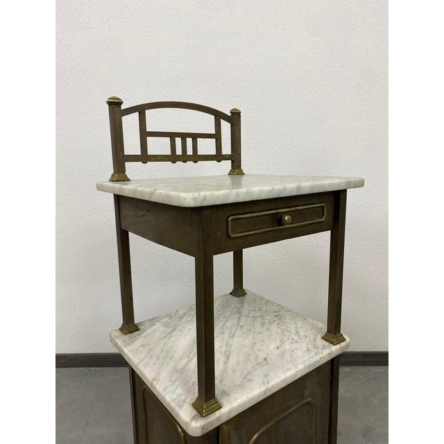 Brass bedside table with marble top. Maximum height is 101cm height of the marble top is 83cm from the floor.