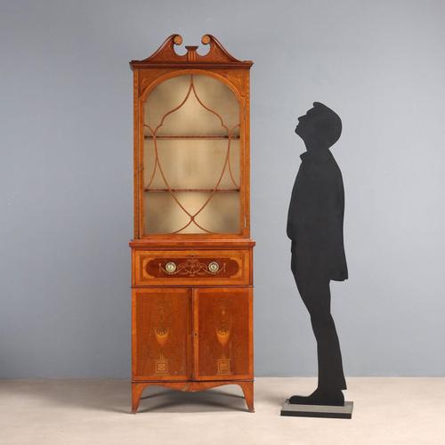 Mahogany bookcase richly inlaid with maple. The top features a glass door held in place by a mahogany grille with maple...