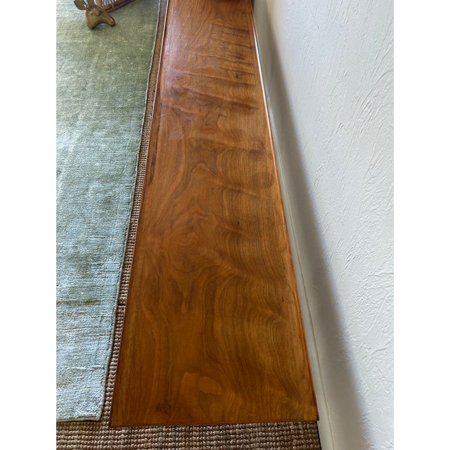 Mid-Century Modern long walnut coffee table or bench designed by Kipp Stewart for Drexel Declaration. Makers mark on...