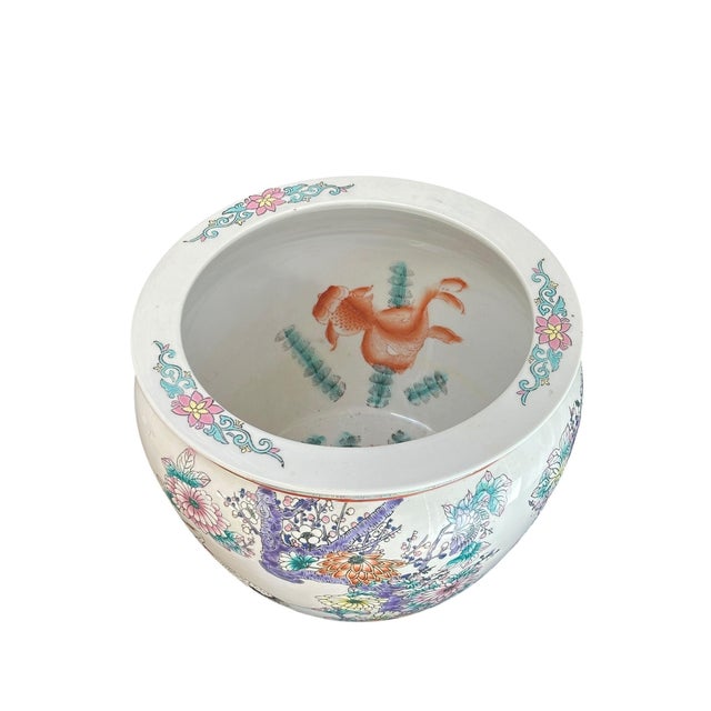 A striking vintage Chinese porcelain fish bowl or jardinière, featuring a classic rounded form with a gently flared rim...