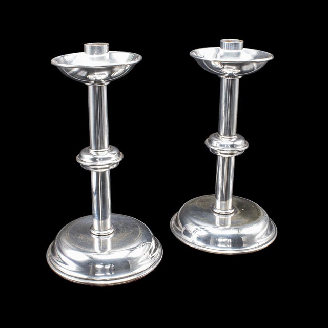 This is a pair of vintage candlesticks. An English, silver plated candle nozzle with later snuffer tool, dating to the mid...