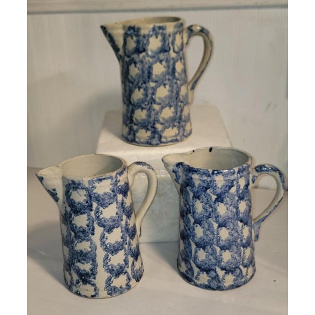 Fine collection of three sponge ware pottery pitchers in a smoke ring pattern. All in good condition with cracks or chips....