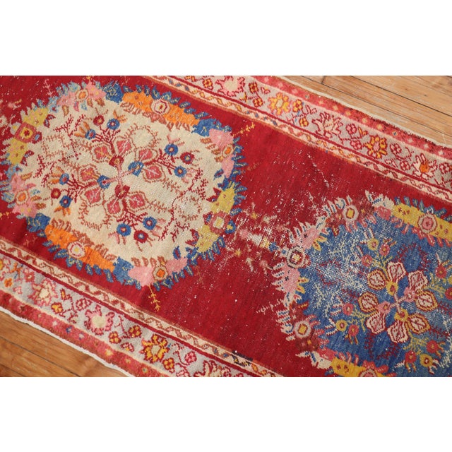 Vintage Turkish Oushak runner with three medallions on a bright red field. Measures: 3' x 10'9''.