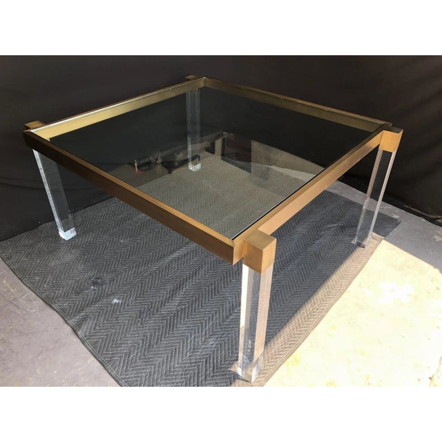 Stunning dining table by Charles Hollis Jones from the "Box Line" collection, executed in Lucite and solid brass with an...