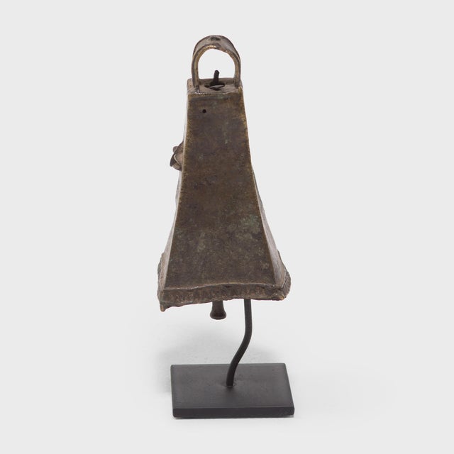 This four-sided brass face bell, known as omo, was created by an artisan of the Ijebu Yoruba people of Southern Nigeria. A...