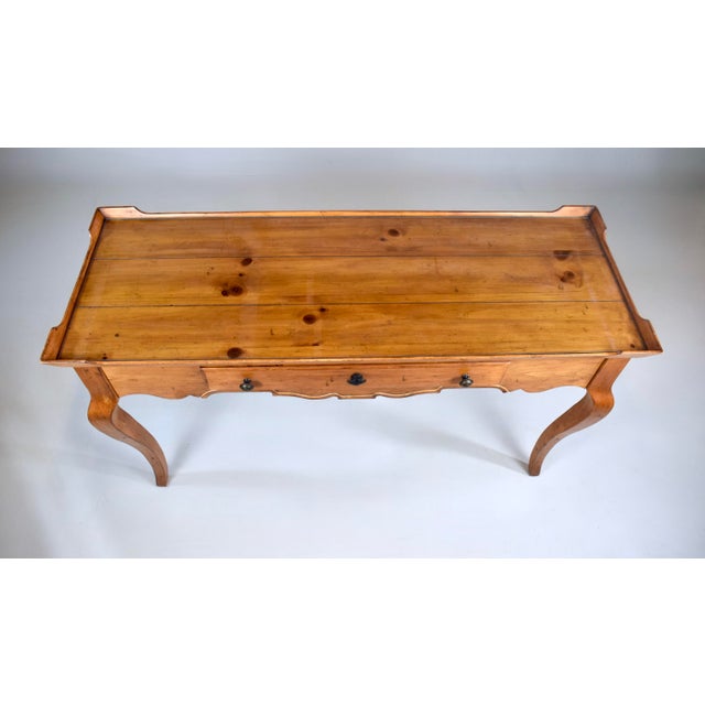 A stylish vintage French Country solid Pine writing desk with single dovetail drawer, custom glass top and classic...