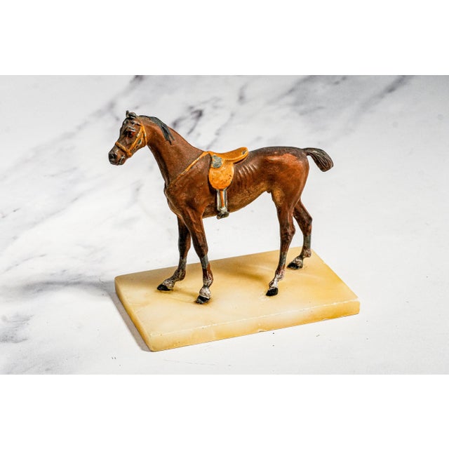 This charming antique cold-painted miniature horse sculpture, dating to circa 1915, captures the character and elegance of...