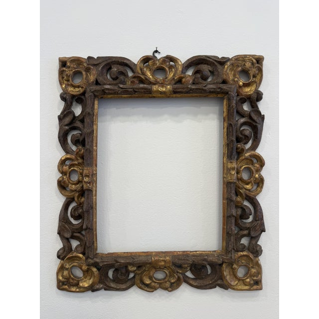 Gilded and bronzed wooden frame from the 17th century, central Italy. This Louis XIV frame features fine carvings with...
