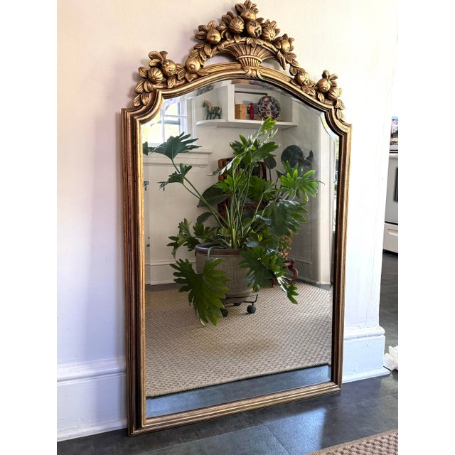 Large ornate gold giltwood style mirror topped with pomegranate fruits in a basket. Sturdy and solid. Please see condition...