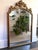 Large ornate gold giltwood style mirror topped with pomegranate fruits in a basket. Sturdy and solid. Please see condition...