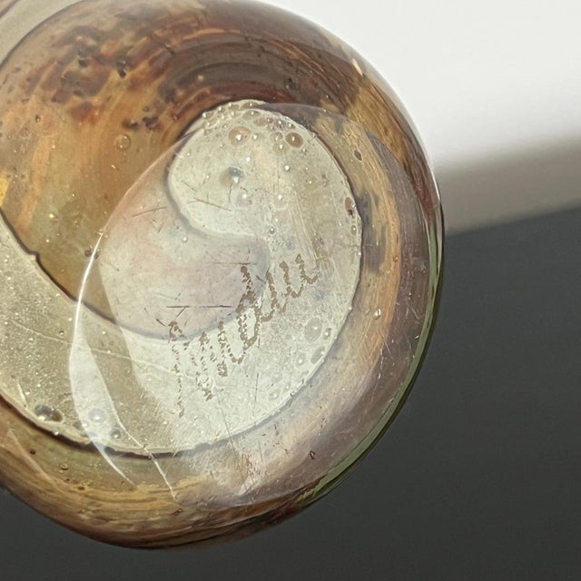 A rare and highly collectable bud vase by Mdina glassware, established in 1968 in Malta by Michael Harris, a lecturer in...