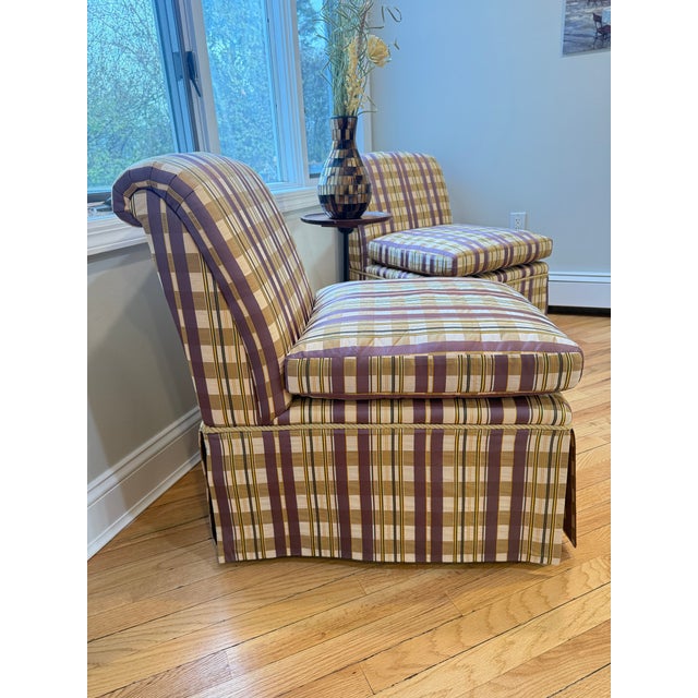 Refined pair of Baker Furniture slipper chairs featuring a classic armless silhouette and tailored plaid upholstery....