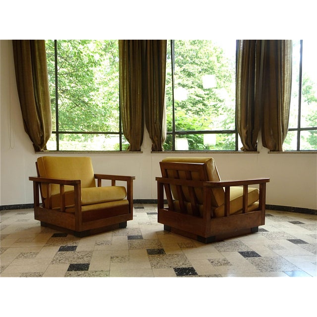A fine cubic-shaped pair of Art Deco armchairs in walnut and velvet, manufactured in Germany during the early 1920s. These...