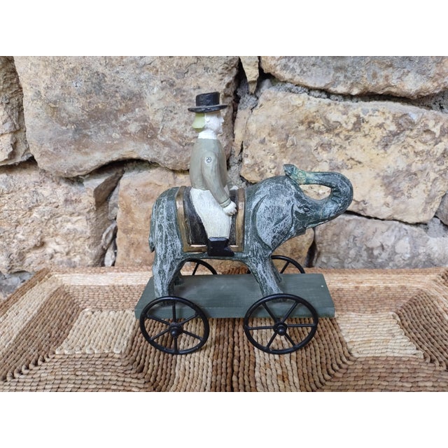What a delight this little male wooden figure is, atop his wheeled elephant. In keeping with Tory Burch's New York...
