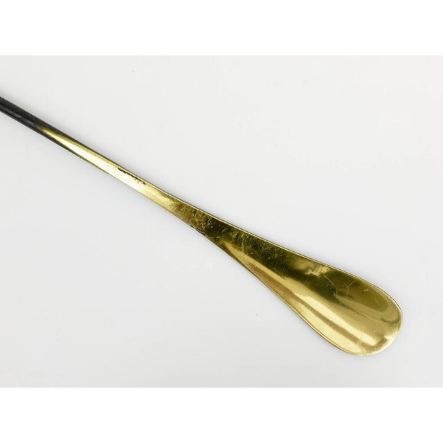 A beautiful brass shoe horn, displaying a cow. A humorous design by Walter Bosse, executed by Hertha Baller Austria in the...