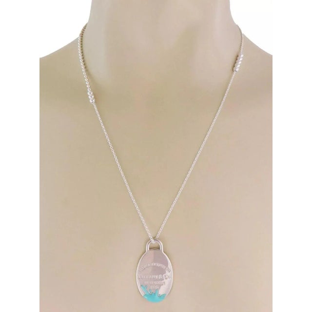 Brand: Tiffany & Co. Hallmark: Tiffany & Co. Ag925 Material: sterling silver and enamel Measurements: adjustable chain: 28...