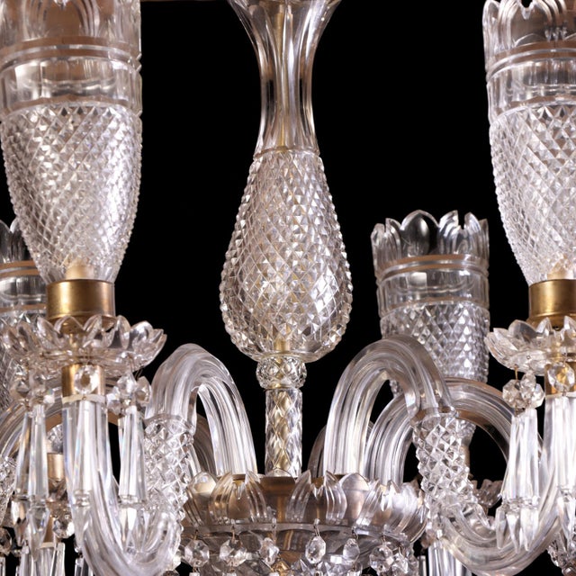 An elegant Osler-style cut glass chandelier of finely proportioned form, centered by a shaped baluster standard richly...