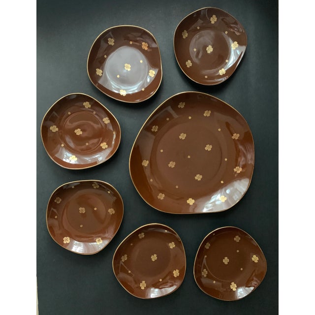An elegant vintage porcelain dessert and cake serving set for six guests, comprising six dessert plates and one larger...