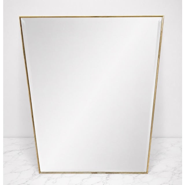 Beautifully elegant vintage brass framed wall mirror in a Hollywood regency style. This piece is in exceptional condition...