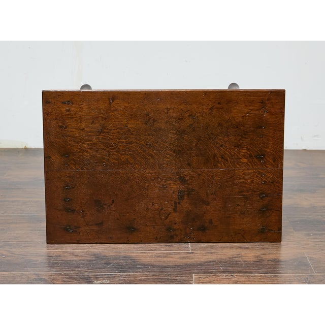 A charming English Georgian oak side table, circa 1800–1830, with elegant cabriole legs and a single drawer featuring...