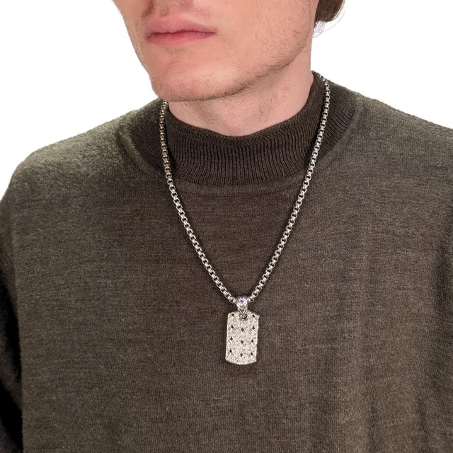 A fine dog tag pendant. By John Hardy. In sterling silver. With round white sapphires set in a cable pattern to the front...