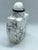 The stone is howlite, a calcium borosilicate hydroxide. It is naturally white with grey veins. The snuff bottle has a...