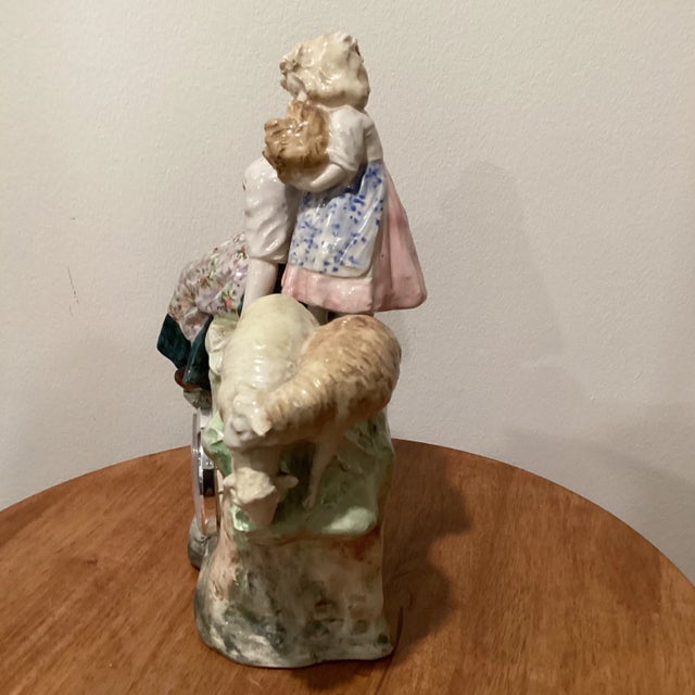 Antique German Porcelain Figural Mantel Clock with mother and daughter and couple baby goats figurines. Chairish sells...