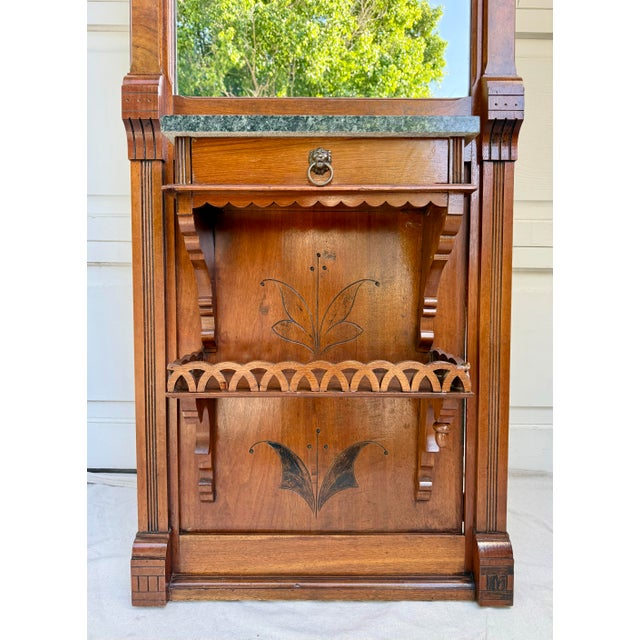 Here is a beautifully detailed late 19th-century Eastlake Aesthetic Movement hall mirror, dating to the 1880s–1890s,...