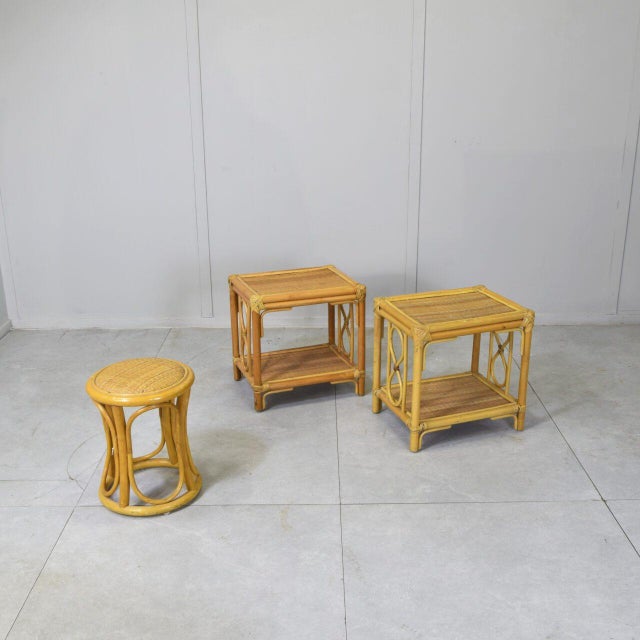 A pair of side tables and a matching stool, both made of bamboo and rattan from the 1970s. The "infinity" (or figure-...