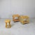 A pair of side tables and a matching stool, both made of bamboo and rattan from the 1970s. The "infinity" (or figure-...